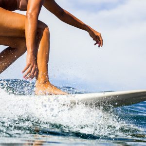 Surfing time for sporty lady.