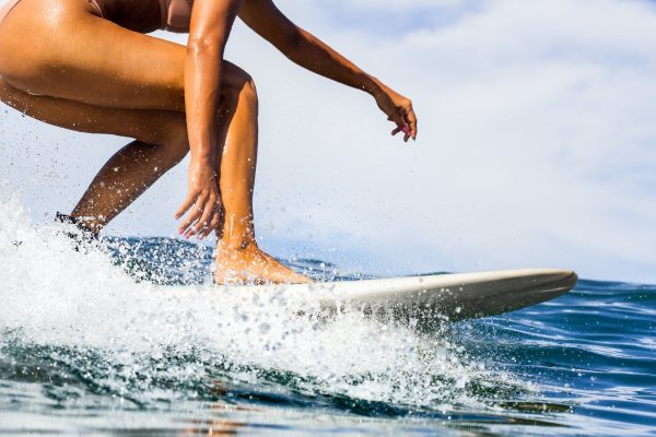 Surfing time for sporty lady.